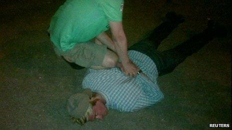 Photo allegedly showing Mr Fogle being held face down on the ground (14 May 2013)