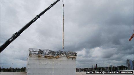 Periscopes being lifted onto HMS Alliance