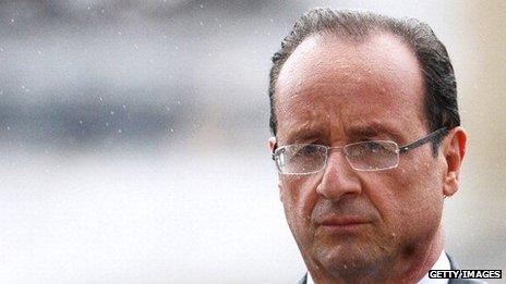 Francois Hollande attends a ceremony in the rain to pay respect to the Unknown soldier at the Arc de Triomphe on 15 May 2012 in Paris.