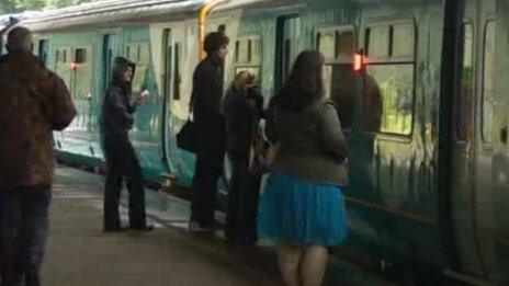 Rail travellers prepare to board a train