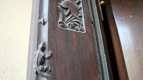 Carvings of a lizard and a helmet at Central fire station