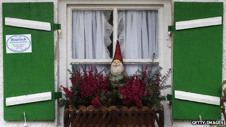 A typical German garden gnome in a window box