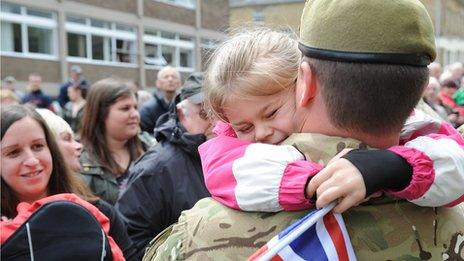 A girl hugs a soldier from the Duke of Lancaster's Regiment