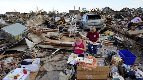 Standy Stewart (r) and her pregnant daughter-in-law Robyn Rojas have their dinner at what left of their tornado devastated home on 21 May, 2013 in Moore, Oklahoma.