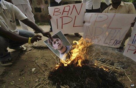 Activists of Kalinga Sena, a local political party, hold placards as they burn a poster of Indian cricketer Shanthakumaran Sreesanth at a protest against spot fixing during the Indian Premier League (IPL) in Bhubaneswar, India, Friday, May 17, 2013