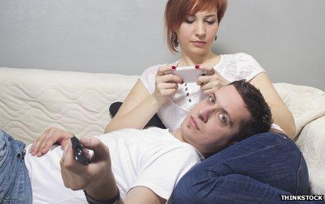 Couple watching TV with smartphone