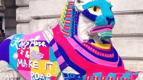 Yarn bombed stone lion in Nottingham