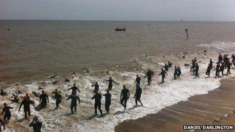 Swimmer enter the sea at Southwold
