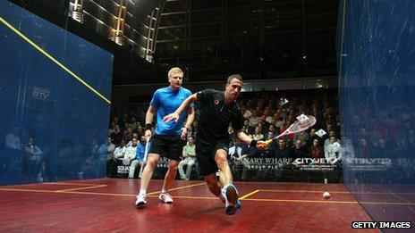 Peter Barker of England plays Tom Richards of England (l) during their quarter-final match in the Canary Wharf Squash Classic on March 20, 2013 in London