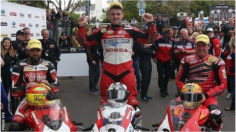 Michael Dunlop celebrates victory with runner-up Cameron Donald and third-placed John McGuinness