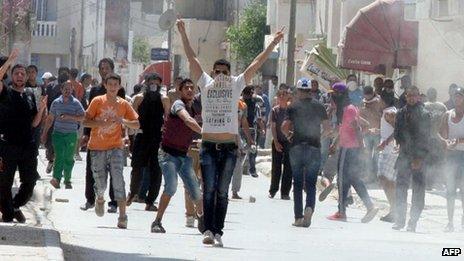 Protesters clash with the Tunisian security force on 19 May 2013 in Ettadhamen, a poor neighbourhood 15 kilometres