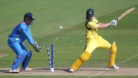 Australia batsman Adam Voges (right) is bowled as India's MS Dhoni looks on