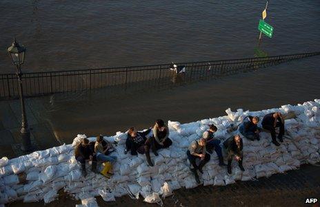 People sit on sandbags in Dresden, 4 June