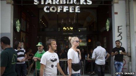 Tourists walk past Starbucks in Istanbul