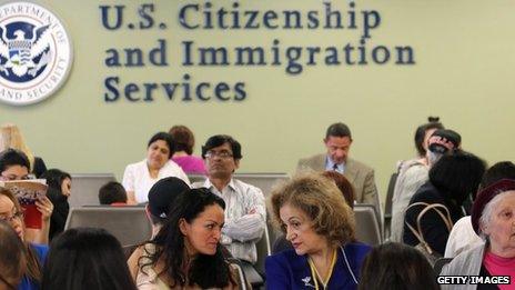 Immigrants await their turn for green card and citizenship interviews at the US Citizenship and Immigration Services (USCIS) office in Queens, New York City 30 May 2013