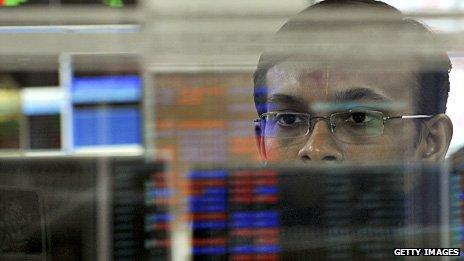 An Indian stockbroker reacts while watching share prices on his screen during intraday trade at a brokerage house in Mumbai in 2011