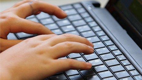 Person typing on keyboard