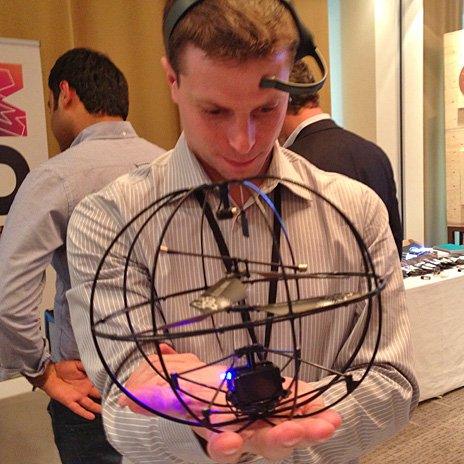 A man wearing a headset to power a Puzzlebox helicopter