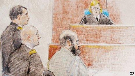 In this courtroom sketch, U.S. Army Maj Nidal Hasan, right, sits during a hearing at Fort Hood, Texas, 11 June 2013