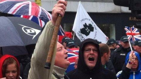 Protesters holding union flags and others holding republican flags gathered in the same area as the G8 march