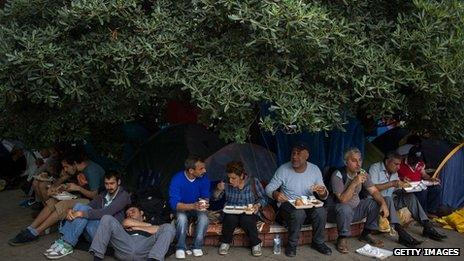 People have lunch under the tree at Taksim Square