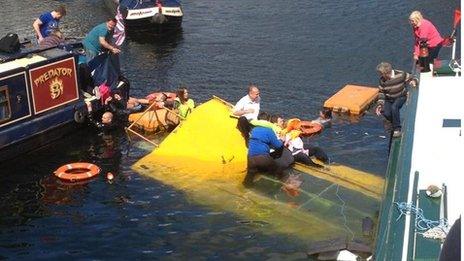 People being rescued from the sinking duck marine