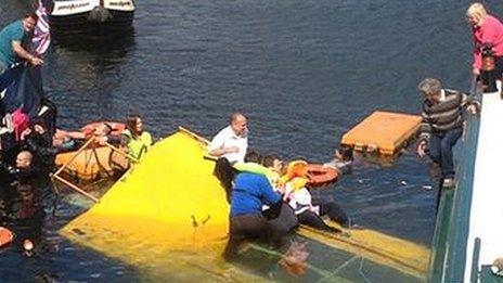 People being rescued from the sinking duck marine