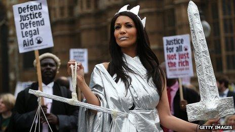 A protestors dressed as Lady Justice during a demonstration in support of Legal Aid near Parliament on May 22, 2013 in London