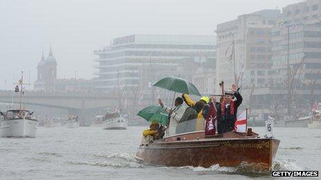 Rain-soaked Thames river pageant