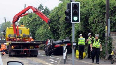 Truck and overturned car at scene of crash