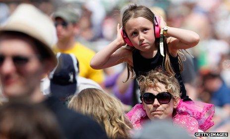 Girl in ear defenders at a festival