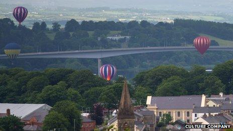 The balloons floatpast the Foyle Bridge