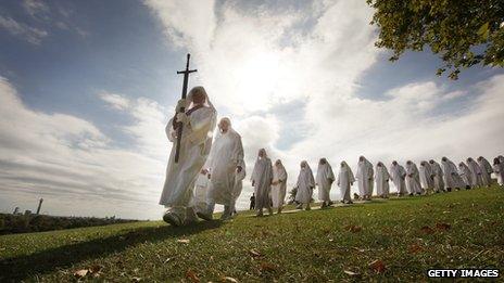 Druids dressed in white march in single file on Primrose Hill to celebrate the Autumn equinox