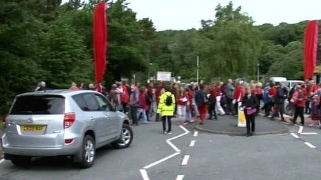 Protestors walking across zebra crossings