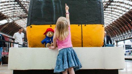 Young girl with the train cake