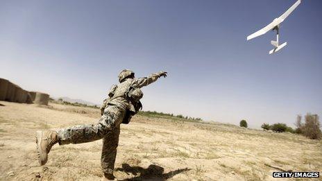 A US soldier tries to launch a small drone in Afghanistan