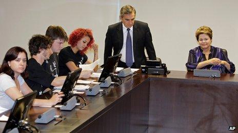 Brazil's President Dilma Rousseff, right, and Gilberto Carvalho, secretary-general of the presidency of Brazil, second right, arrive for a meeting with representatives of the Free Fare Movement