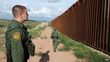 US Border Patrol agents Colleen Agle and Richard Funke patrol the border between Arizona and Mexico at the town of Nogales 28 July 2010