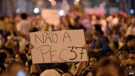 A protester holds up a banner saying: "No to PEC 37" at a demonstration in Niteroi, Rio de Janeiro State (25 June 2013)