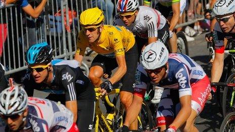 Multi-branded cyclists compete in the 2012 Tour De France