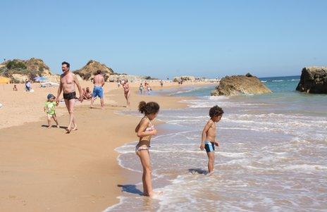 Holidaymakers on a beach in the Algarve