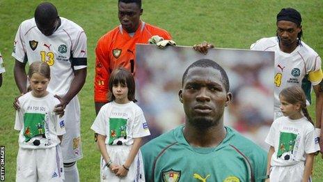 Cameroon players hold a picture of Marc-Vivien Foe