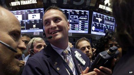 Trader Jonathan Corpina smiles as he works on the floor of the New York Stock Exchange