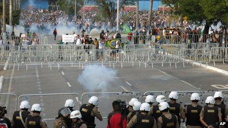 Police fire tear gas at protesters trying to reach the Mineirao Stadium where Brazil was playing Uruguay