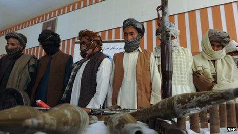 Former Taliban fighters stand in front of the media after joining Afghan government forces during a ceremony in Herat on on 26 June 2013