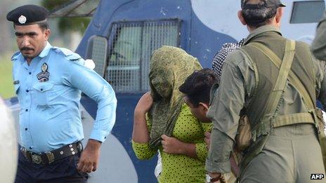 Pakistani security personnel move Rimsha Masih (2L), a Christian girl accused of blasphemy, to a helicopter after her release from jail in Rawalpindi on September 8, 2012.