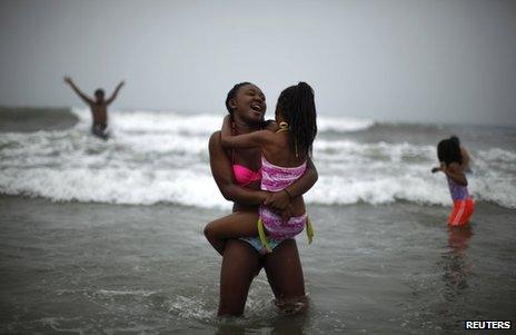 Daleigh Bigby, 7 (R), and Sydney, 16, cool off in the Pacific ocean during a heat wave sweeping the Southwest United States in Santa Monica, California, on Friday