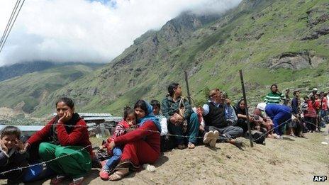 Stranded Indian pilgrims wait in line for their turn to be evacuated in an Indian Air Force helicopter at Badrinath on June 29, 2013