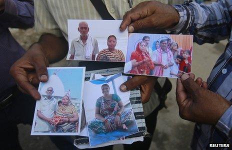 Relatives of missing people, affected by the flash floods and landslides, display their photographs outside the Indian Air Force base in Dehradun, in the Himalayan state of Uttarakhand June 26, 2013