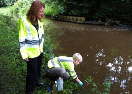 Environment Agency officials taking samples from a canal